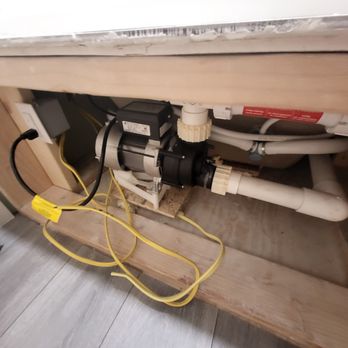 NM Construction - a water pump under a sink - Damage Restoration Near Me NM Construction - a water pump under a sink - Damage Restoration Near Me