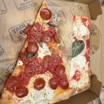 Table 87 - Industry City - Pepperoni slice and underneath burrata slice - Pizza Near Me - Brooklyn, New York