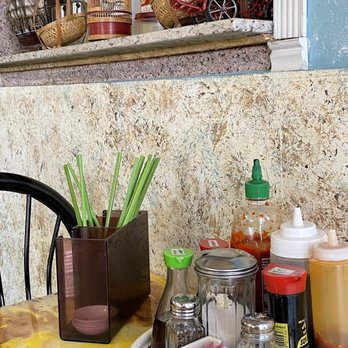 Que Huong Restaurant - a table with condiments and condiments - Vietnamese Near Me - Phoenix, Arizona