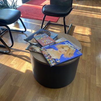 J Barber Shop - Table with old school hair style books - Hair Salons Near Me - San Jose, California