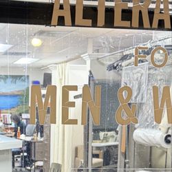 Peter's Tailor Shop - Business hours and open signs plus the worker inside the store