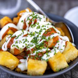 Puerta del Sol - Papas Braviolis ($12) Triple cooked Spanish potatoes, smokey brava sauce and aioli sauce.