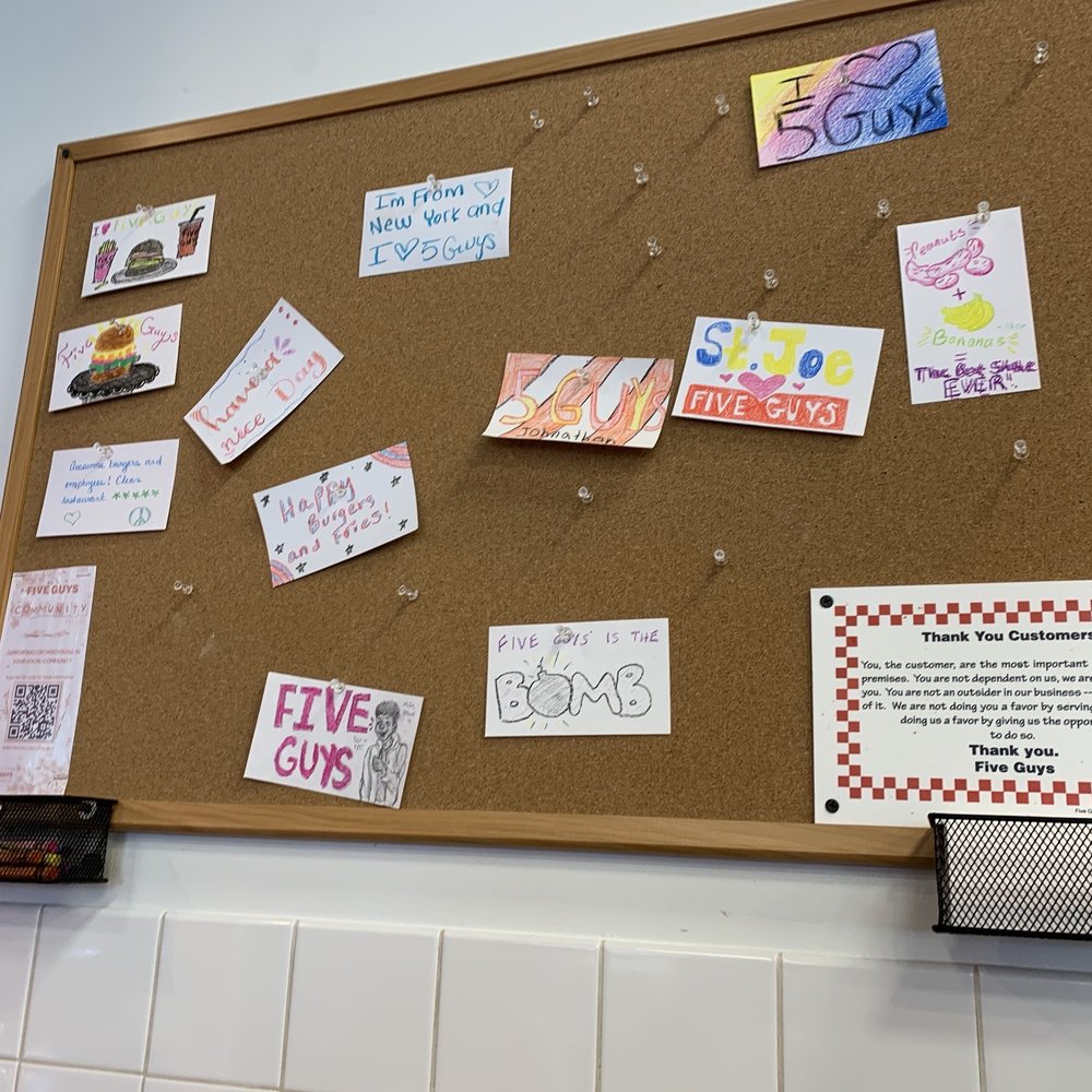 Five Guys - a cork board with notes on it - Burgers Near Me - St. Joseph, Michigan
