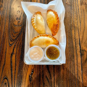 DelSur Empanadas - a basket of empanadas on a wooden table - Empanadas Near Me - Minneapolis, Minnesota