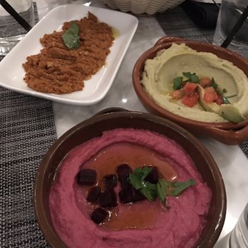 Zatar - Muhammara with roasted red peppers, walnuts, and pomegranate molasses (my personal favorite), hummus, and roasted beets hummus. - Lebanese Near Me - Dallas, Texas Zatar - Muhammara with roasted red peppers, walnuts, and pomegranate molasses (my personal favorite), hummus, and roasted beets hummus. - Lebanese Near Me - Dallas, Texas