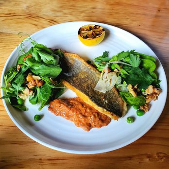 The Lark - Cast Iron Mediterranean Branzino. muhamara, english peas, walnuts, pickled fennel, charred lemon, pea tendrils. - New American Near Me - Santa Barbara, California The Lark - Cast Iron Mediterranean Branzino. muhamara, english peas, walnuts, pickled fennel, charred lemon, pea tendrils. - New American Near Me - Santa Barbara, California