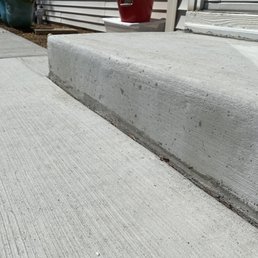 Brand new stoop they poured. Splatter and marks everywhere
