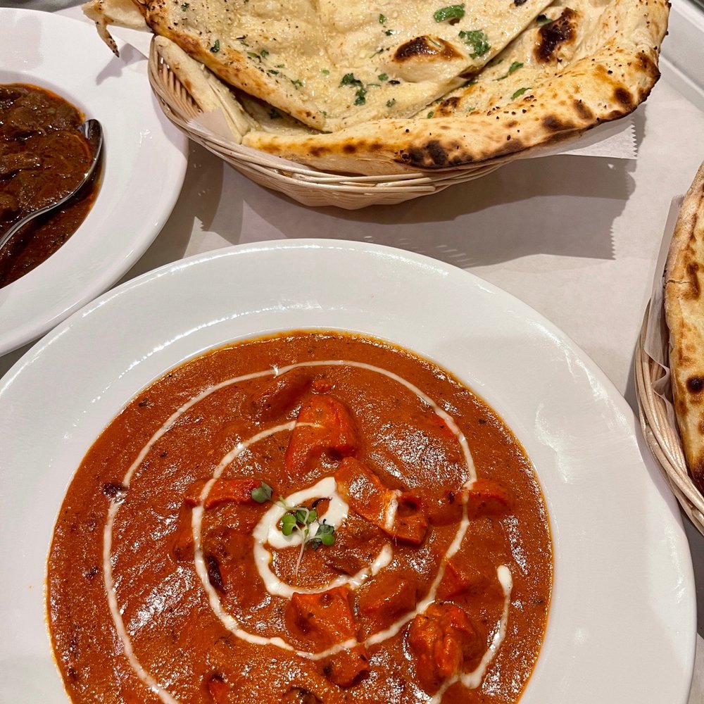 Tamarind - a bowl of tomato soup and a plate of naan bread - Indian Near Me - Newtown, Connecticut Tamarind - a bowl of tomato soup and a plate of naan bread - Indian Near Me - Newtown, Connecticut