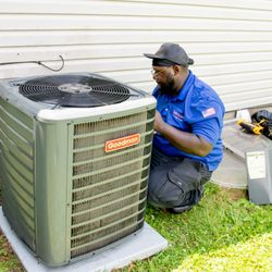 Johnson Heating, Cooling, and Plumbing - Technician checking A/C system.