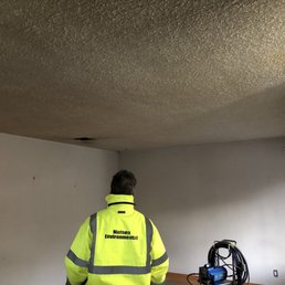Before - popcorn ceiling in living room.