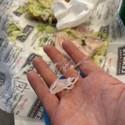 Lennys Grill & Subs - This was in our sand which- a long piece of plastic so disgusting. Tried multiple times to call but the line is always busy. So gross