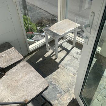 The Oceanfront Hotel - Old rusty and wooden chairs and table on the balcony - Hotels Near Me - Half Moon Bay, California The Oceanfront Hotel - Old rusty and wooden chairs and table on the balcony - Hotels Near Me - Half Moon Bay, California