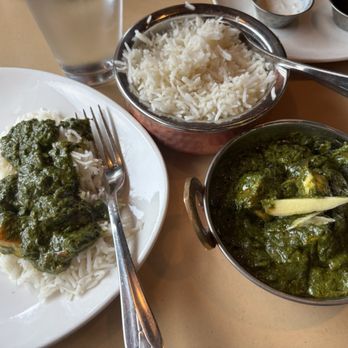 Spice Room - A meal featuring rice, a green curry, and a plate with rice topped with green sauce, served with a glass of water. - Indian Near Me - Arvada, Colorado