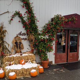 a hay bale with a scarecrow and pumpkins a hay bale with a scarecrow and pumpkins