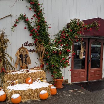 Da Capo - a hay bale with a scarecrow and pumpkins - Pizza Near Me - Litchfield, Connecticut