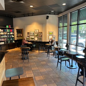 Starbucks - a woman sitting at a table in a coffee shop - Coffee & Tea Near Me - Mobile, Alabama Starbucks - a woman sitting at a table in a coffee shop - Coffee & Tea Near Me - Mobile, Alabama