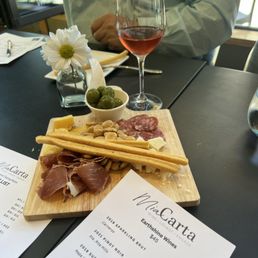 a plate of food and a glass of wine a plate of food and a glass of wine