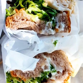 Pickles and Olives - Turkey sandwich with avocado spread, and romaine lettuce on a nut and grain bread. - Caterers Near Me Pickles and Olives - Turkey sandwich with avocado spread, and romaine lettuce on a nut and grain bread. - Caterers Near Me