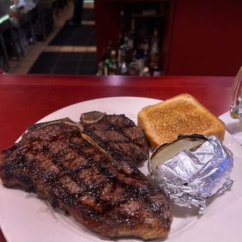 Prime Quarter Steak House - T - bone steak cooked deliciously with a potato and Texas toast - Steakhouses Near Me - Green Bay, Wisconsin Prime Quarter Steak House - T - bone steak cooked deliciously with a potato and Texas toast - Steakhouses Near Me - Green Bay, Wisconsin
