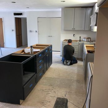 PM Contracting Team - a man working on a kitchen island - General Contractors Near Me
