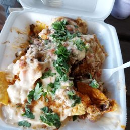 Greasy nachos and what seems to be fake cheese