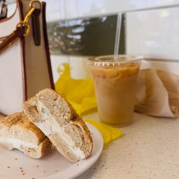 Kneller’s Delicatessen & Appetizing - GF sesame bagel with scallion cream cheese and iced coffee - Delis Near Me - Tucson, Arizona