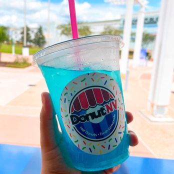 DonutNV - a hand holding a cup of blue liquid with sprinkles - Food Trucks Near Me