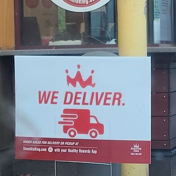 Smoothie King - a we deliver sign in front of a fast food restaurant - Juice Bars & Smoothies Near Me - Flemington, New Jersey