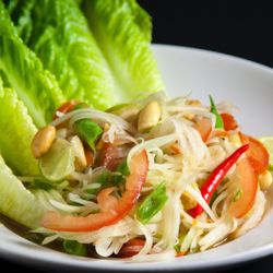 Papaya Salad: fresh shredded green papaya with carrots, tomatoes, green beans, peanuts, tamarind lime sauce. Request no fish sauce for Vegan