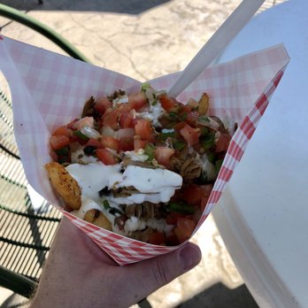 Flatbreads & Fry Cones - a hand holding a flatbread - Food Stands Near Me - San Diego, California