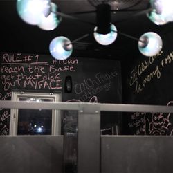 The Works - Second-floor restroom with chalkboard walls where guests can leave messages and artwork at The Works in Indianapolis.