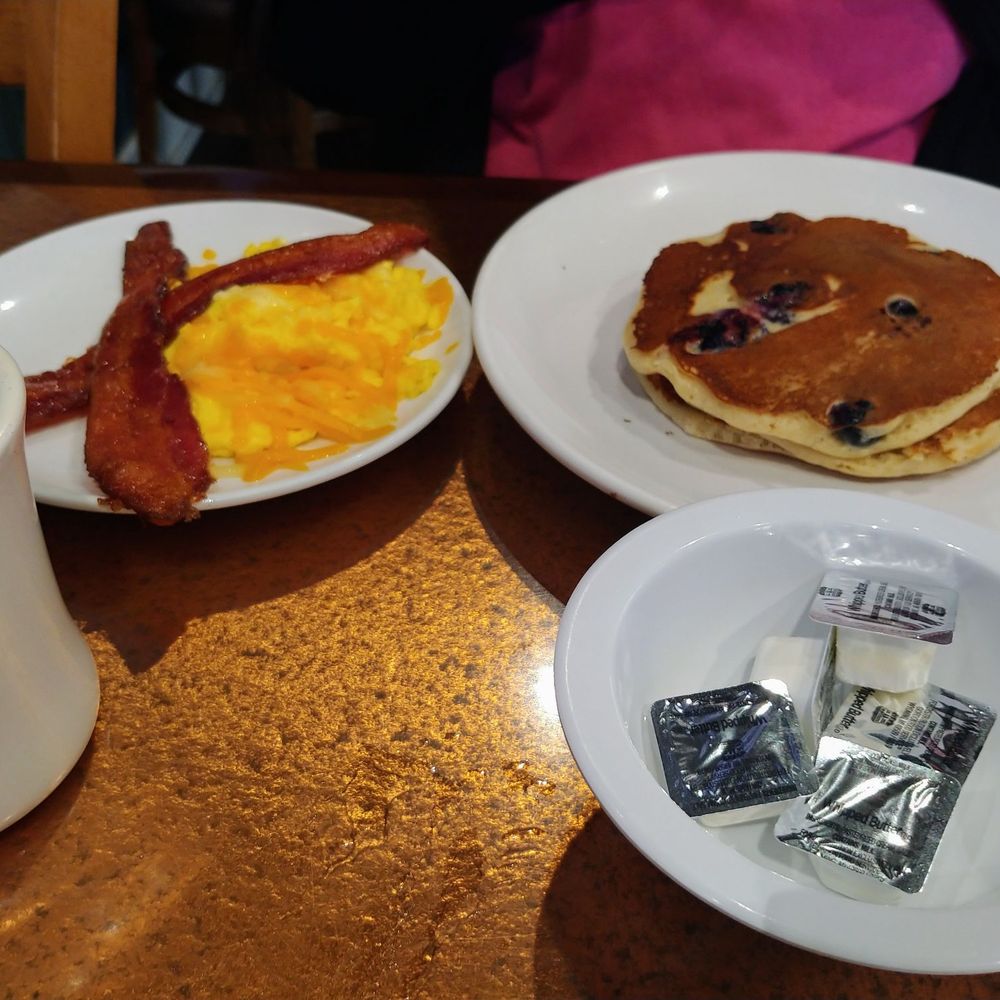Another Broken Egg Cafe - Buttermilk pancakes with fresh blueberries and a side of eggs and bacon. - Breakfast & Brunch Near Me - Shenandoah, Texas Another Broken Egg Cafe - Buttermilk pancakes with fresh blueberries and a side of eggs and bacon. - Breakfast & Brunch Near Me - Shenandoah, Texas