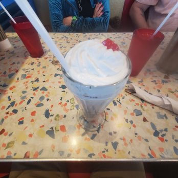 Flashback Breakfast & Lunch - a woman sitting at a table with a bowl of whipped cream - Breakfast & Brunch Near Me - Barrie, Ontario