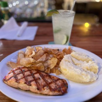 Hideaway Bar & Grill - Salmon grilled in herb butter with garlic mashed potatoes and homemade potato chips - Bars Near Me - Castle Rock, Colorado