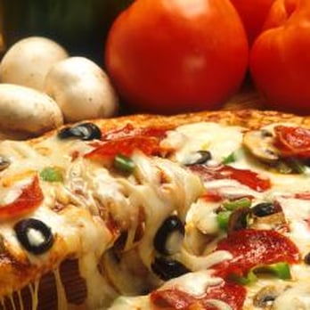 Tyroni's Pizza - a slice of pizza on a cutting board - Italian Near Me - Peoria, Illinois Tyroni's Pizza - a slice of pizza on a cutting board - Italian Near Me - Peoria, Illinois