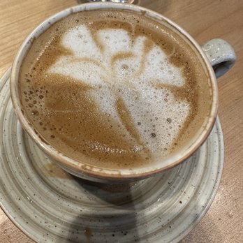Andare Kitchen & Bar - Oatmilk latte. Server said she spilled. Not pretty but super yummy, smooth, and strong! - Pizza Near Me - Seattle, Washington