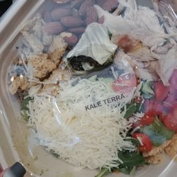 Toss Your Greens - Kale Terra with greens and shredded kale, chicken, almonds, toms and parm crisps