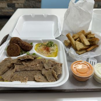 ZamZamz Mediterranean Grill - This is picture of the gyro plate with falafel and hummus sides and puts chips from a previous visit. - Mediterranean Near Me - Memphis, Tennessee ZamZamz Mediterranean Grill - This is picture of the gyro plate with falafel and hummus sides and puts chips from a previous visit. - Mediterranean Near Me - Memphis, Tennessee