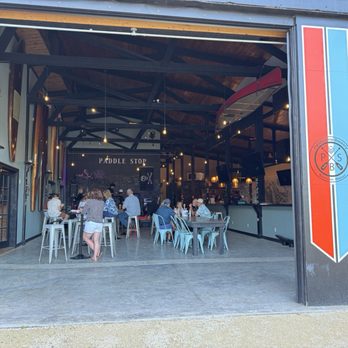 Paddle Stop Brewery - They look inside at the main hall from the back patio - Breweries Near Me - New Haven, Missouri