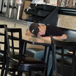 Tokyo Express - Owner sleeping on a table where customers have to eat.