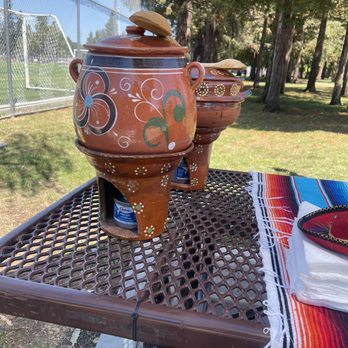 Los Chulo's Tacos - a table with a table cloth and two pots on it - Tacos Near Me - Redwood City, California Los Chulo's Tacos - a table with a table cloth and two pots on it - Tacos Near Me - Redwood City, California