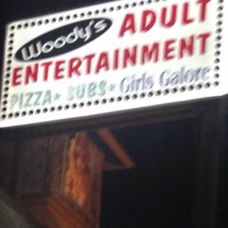 an adult entertainment sign lit up at night