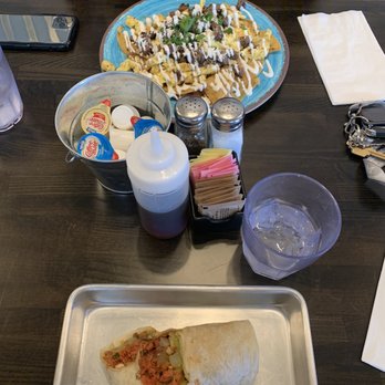 Atticus Cafe - green chilaquiles with scrambled eggs and steak for him, vegan breakfast burrito without jalepenos for me - Breakfast & Brunch Near Me - Anaheim, California