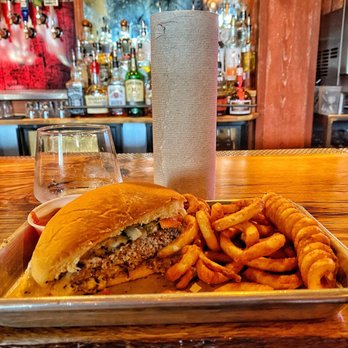 Lucky Rabbit - Half of the half pound Border Burger and curly fries served with a roll of paper towels because it's nice and messy. - Music Venues Near Me - Jonestown, Texas Lucky Rabbit - Half of the half pound Border Burger and curly fries served with a roll of paper towels because it's nice and messy. - Music Venues Near Me - Jonestown, Texas