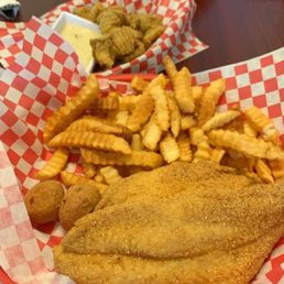 Two catfish plates with fried pickles. Two catfish plates with fried pickles.