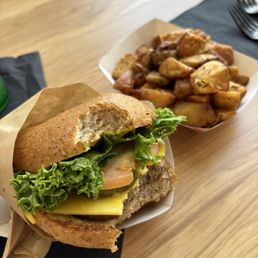 A bite of Mr Mushroom Burger and rosemary potatoes. A bite of Mr Mushroom Burger and rosemary potatoes.