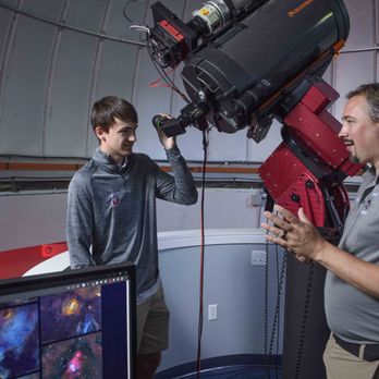 Pomfret School - An astronomy teacher and student inside the Olmsted Observatory. - Education Near Me - Pomfret, Connecticut