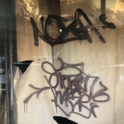 Graffiti over windows and building along this block