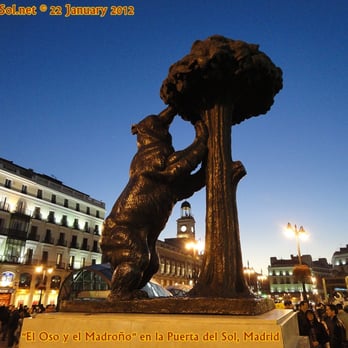 La Puerta del Sol - Statue of Madrid's city symbol, "El Oso y el Madroño" and the "Casa de Correos" clocktower in the gap. January 2012. - Local Flavor Near Me - Madrid, M