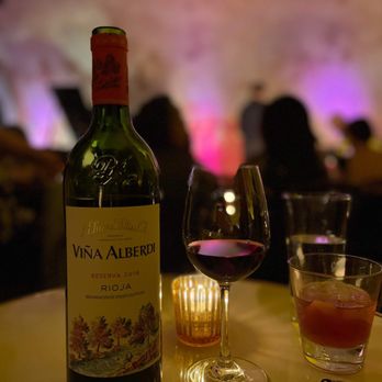 The Django - a bottle of wine and a glass of wine - Jazz & Blues Near Me - New York, New York The Django - a bottle of wine and a glass of wine - Jazz & Blues Near Me - New York, New York